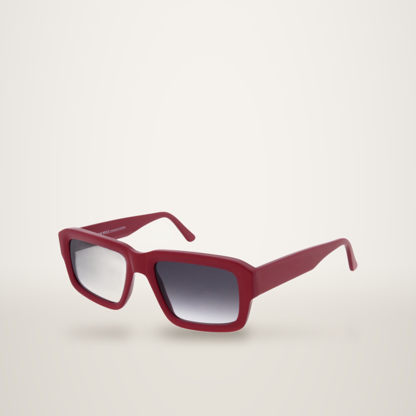 Paire de lunettes de soleil à monture rectangulaire rouge épaisse et verres gris dégradés, présentée sur fond blanc.