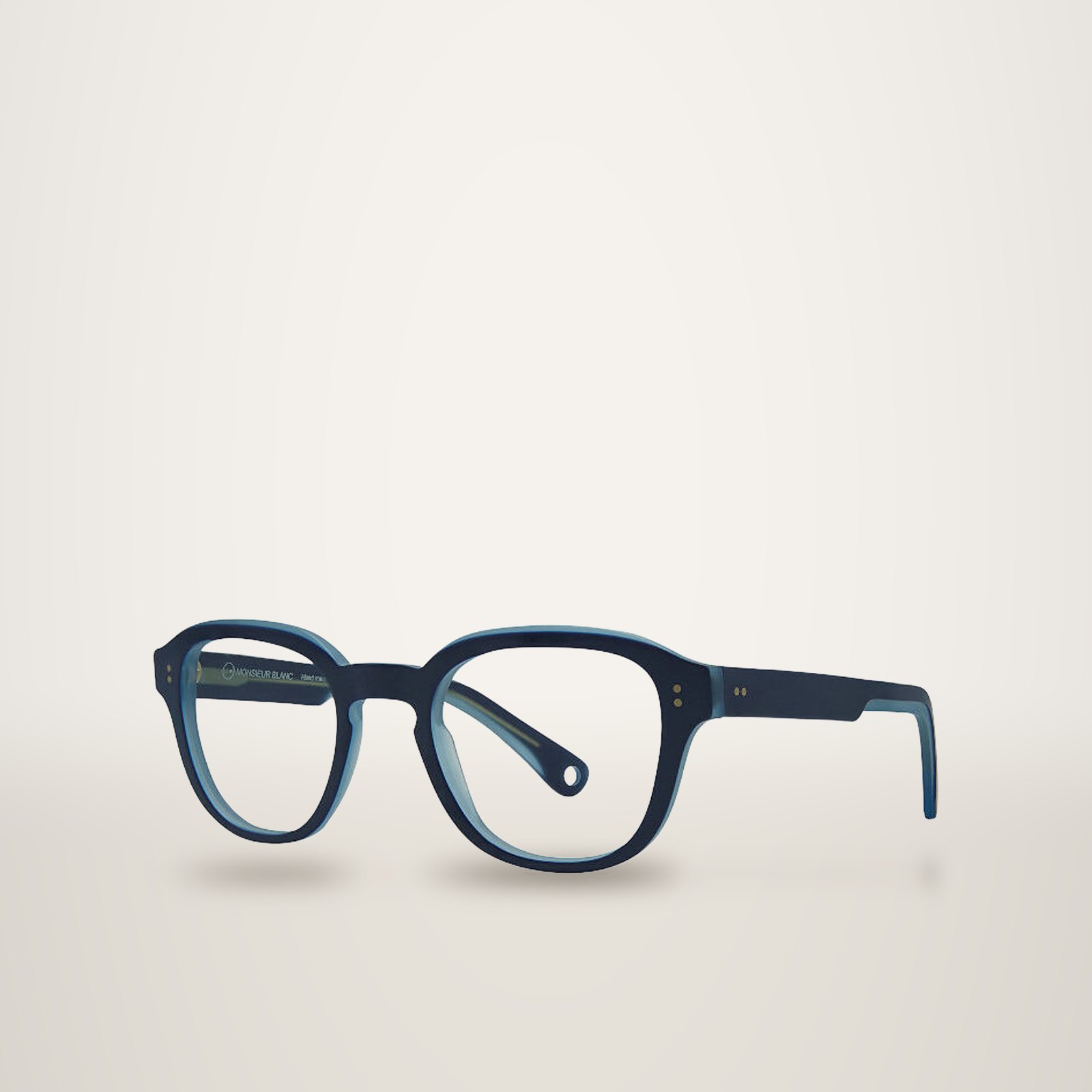 Monture de lunettes en acétate bleu marine et bleu clair, de forme arrondie, photographiée en trois quarts sur fond uni.