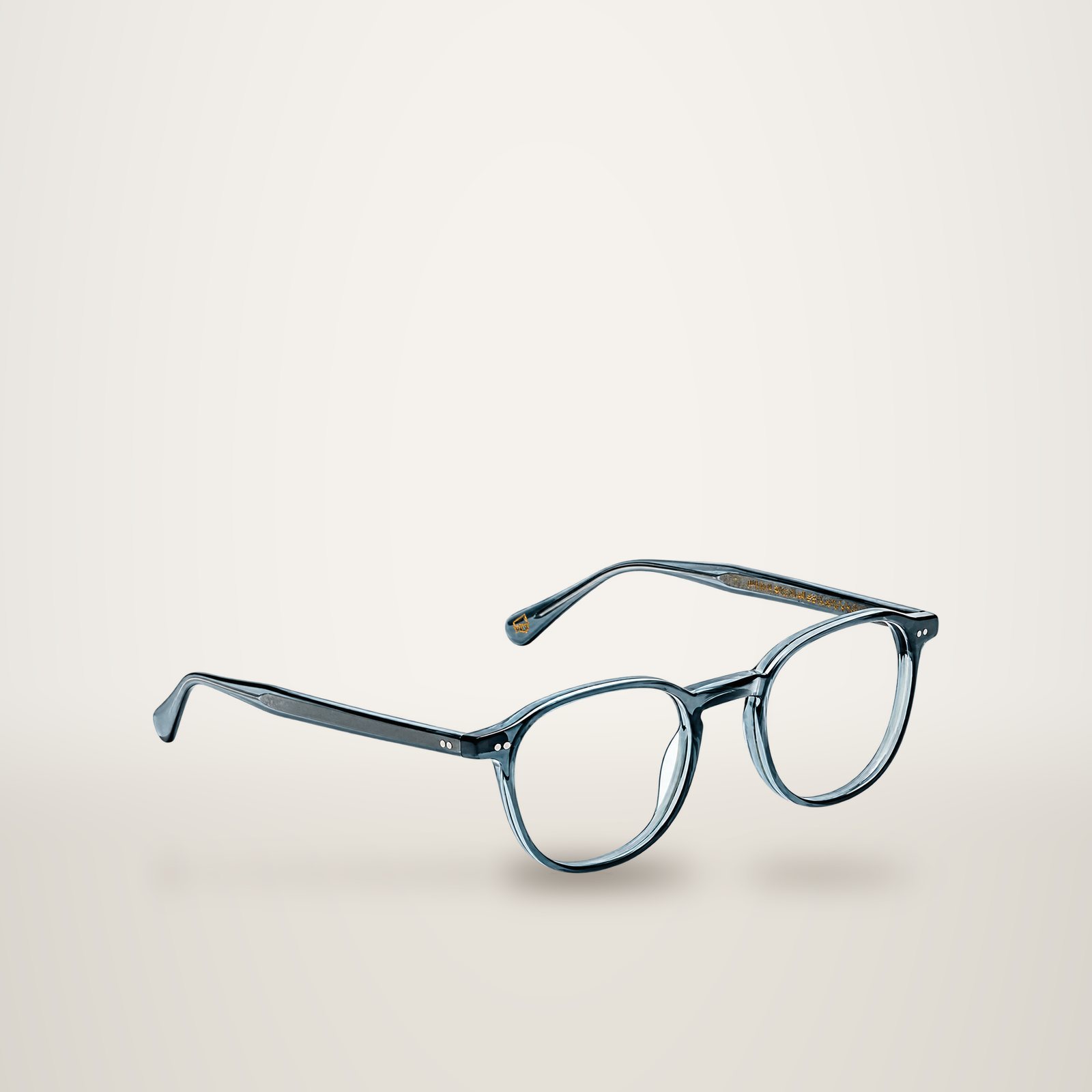 Une paire de lunettes de vue à monture ronde en acétate gris bleuté translucide, présentée en trois quarts sur fond blanc.